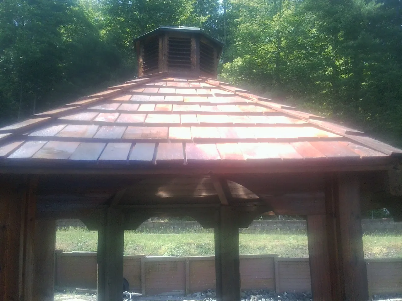 New cedar shake roof and cupola on a lakeside gazebo in Lincoln